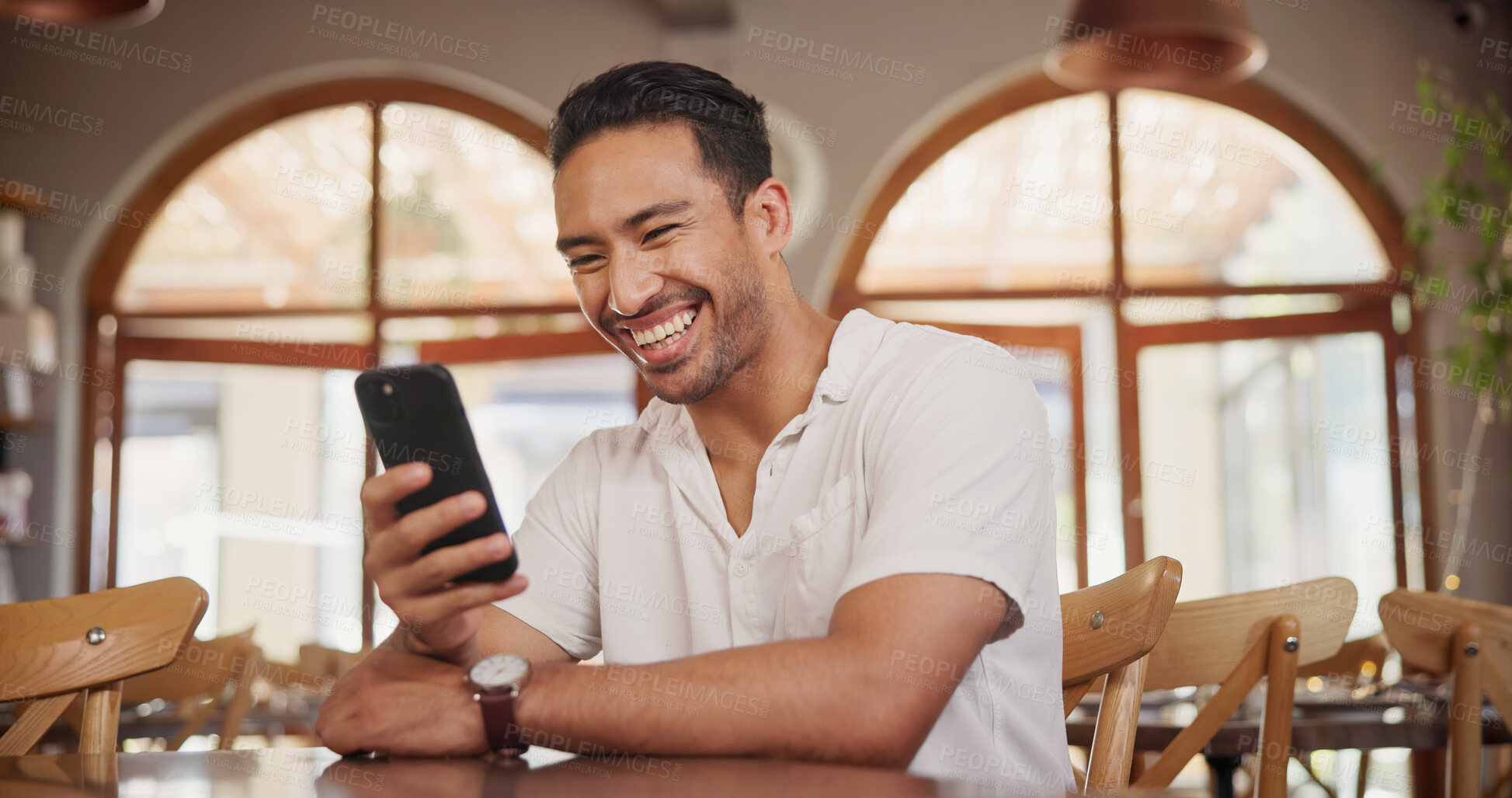 Buy stock photo Laughing, phone and relax with man in restaurant for online review, communication and menu search. Coffee shop rating, funny meme and contact with person and tech for social media, scroll and chat
