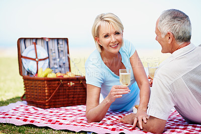 Buy stock photo A portrait of a happy mature woman having a picnic with her husband on a sunny day