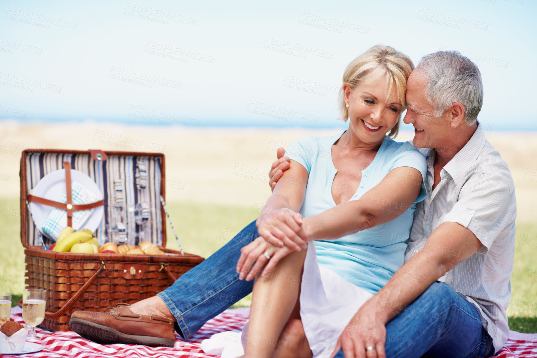 Buy stock photo Laughing, hug and relax with old couple at picnic for connection, bonding and anniversary date. Retirement, love and romantic lunch with senior man and woman in nature for support and vacation