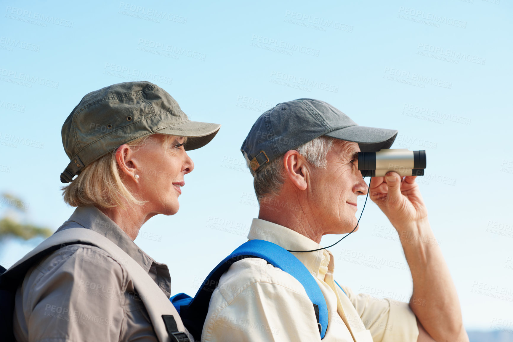 Buy stock photo Binoculars, trekking and explore with old couple in nature for view, adventure and travel. Birdwatching location, search and hiking guide with senior man and woman outdoor for retirement vacation
