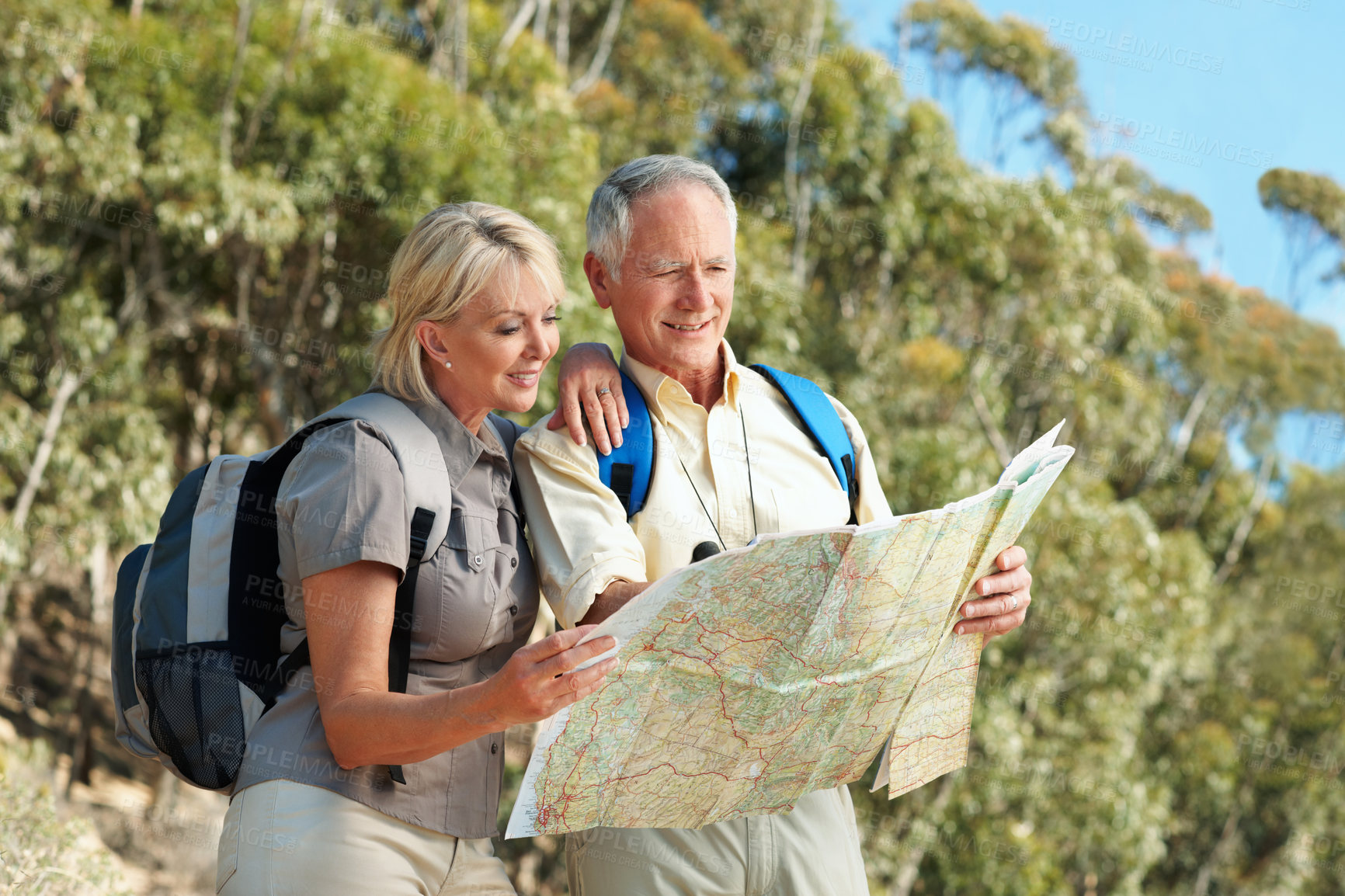 Buy stock photo Navigation, hiking and senior couple with map in nature for direction, exploring or adventure. Happy, backpacking and elderly man with woman in retirement with trekking route chart on vacation.