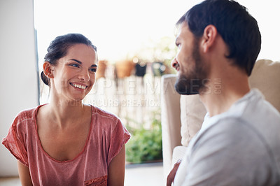 Buy stock photo Shot of a romantic young couple spending quality time together in their living room