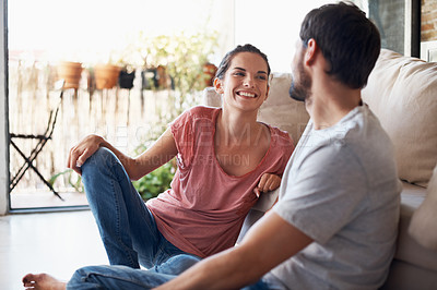 Buy stock photo Shot of a romantic young couple spending quality time together in their living room