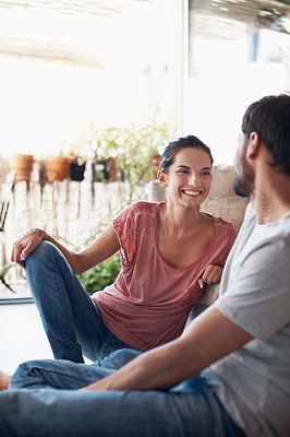 Buy stock photo Shot of a romantic young couple spending quality time together in their living room