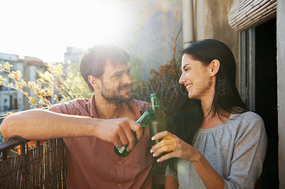 Buy stock photo A loving couple standing on a balcony of their apartment