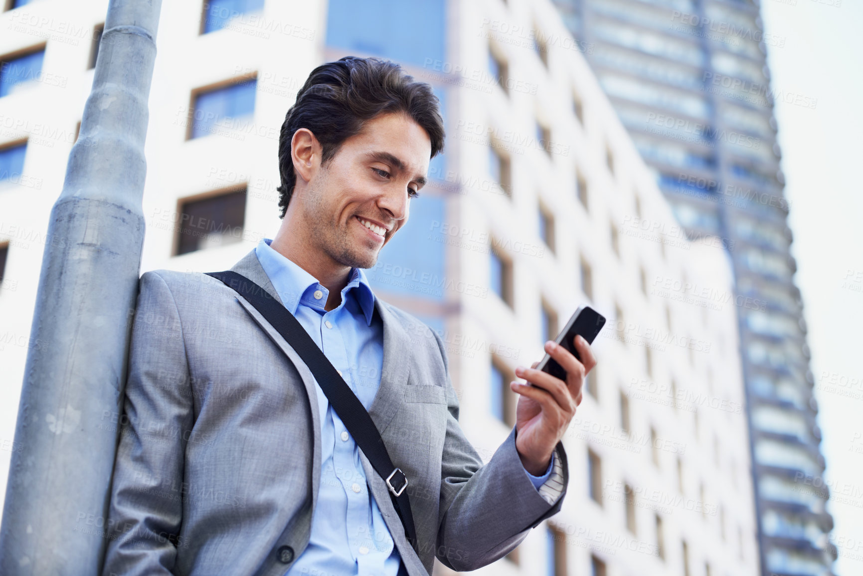 Buy stock photo Business, man and happy with phone in city for vacancy feedback, interview confirmation or email. Person, job seeker and smile with mobile outdoor for work offer, employment opportunity or low angle