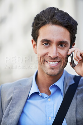 Buy stock photo An attractive businessman using his mobile while in the city central