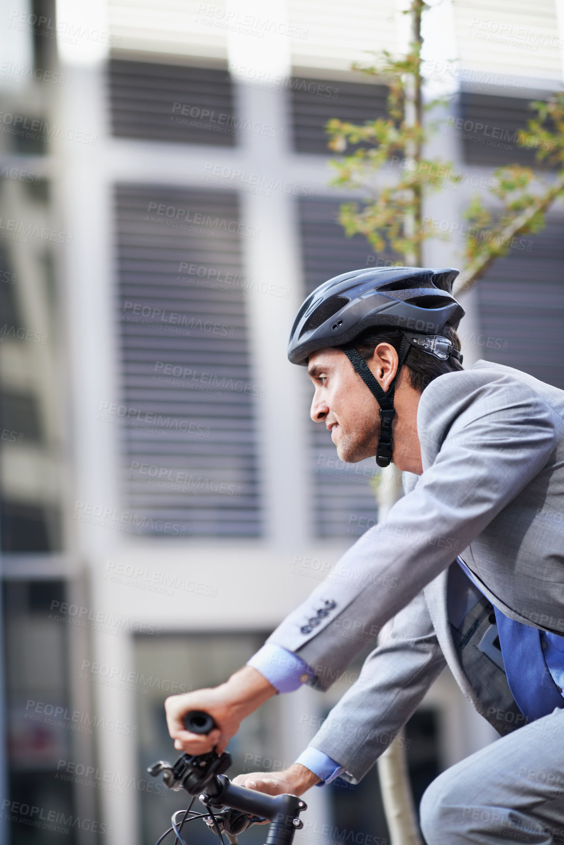 Buy stock photo Business, city and man on bicycle for travel, morning commute and trip with eco friendly transport. Happy, sustainability and person with bike, helmet and cycling to corporate workplace in town 