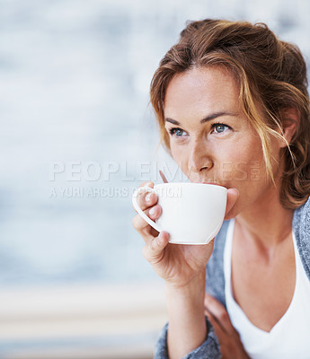 Buy stock photo Woman sitting in coffee shop sipping on her coffee and looking contemplative