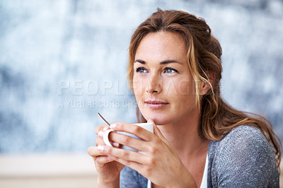 Buy stock photo Woman sitting in coffee shop holding her coffee looking contemplative 