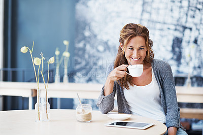 Buy stock photo Portrait of a beautiful woman at a coffee shop holding her touchscreen with her coffee next to her