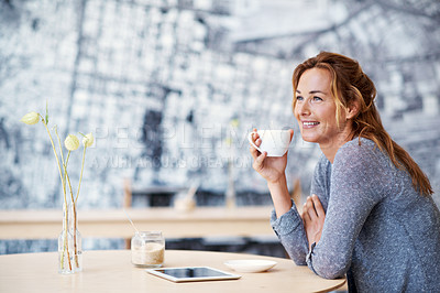 Buy stock photo A beautiful woman in a dream like state in a coffee shop holding her coffee cup with her touchscreen next to her