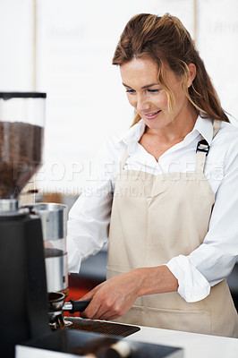 Buy stock photo Portrait of a pretty barista using the coffee machine