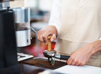 Buy stock photo Close up a barista making coffee through the devices of the coffee machine