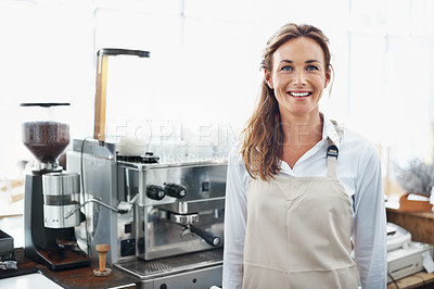 Buy stock photo Portrait of a smiling barista standing in front of a coffee machine