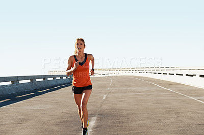 Buy stock photo Young female athlete sprinting along the road wearing sports clothes