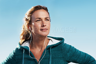 Buy stock photo Young woman wearing a hoodie outdoors looking away from the camera