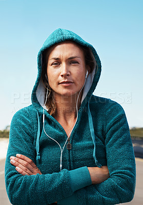 Buy stock photo Young female athlete wearing a hoodie and facing the camera with her arms folded