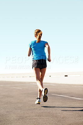 Buy stock photo Female athlete running along a highway wearing sports clothes