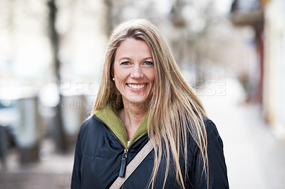 Buy stock photo Portrait of a smiling woman standing in the street