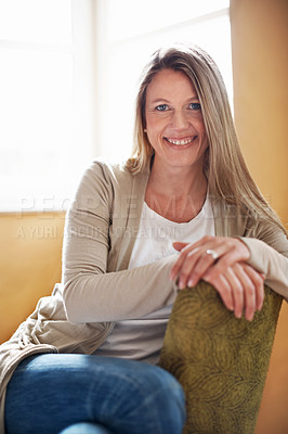 Buy stock photo A beautiful woman sitting on a chair in her living room