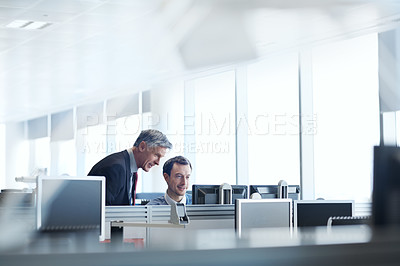 Buy stock photo Shot of a senior businessman looking at a young colleague's computer screen