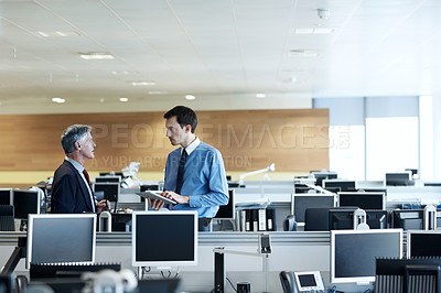 Buy stock photo Shot of two businessmen discussing something in the office