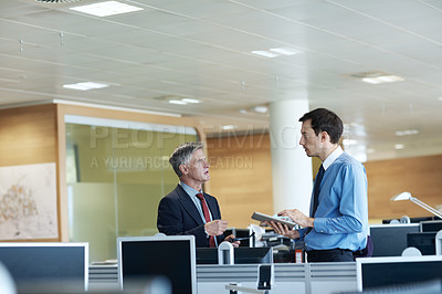 Buy stock photo Shot of two businessmen discussing something in the office