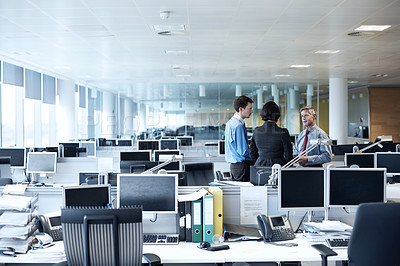 Buy stock photo Shot of three businesspeople discussing something in the office