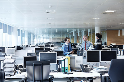 Buy stock photo Shot of three businesspeople discussing something in the office