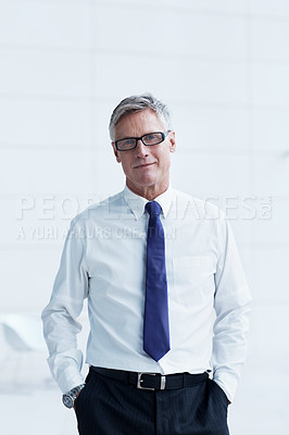 Buy stock photo Portrait of a confident senior businessman standing against a white background