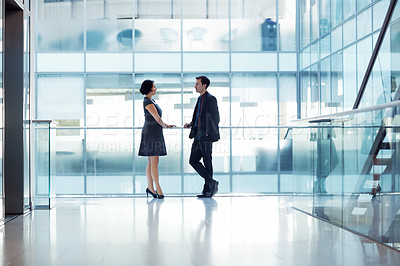 Buy stock photo Shot of two businesspeople having a conversation in an office setting