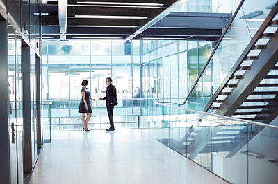 Buy stock photo Shot of two businesspeople having a conversation in an office setting