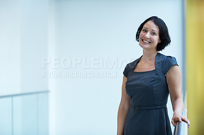 Buy stock photo Portrait of a smiling young businesswoman in an office setting
