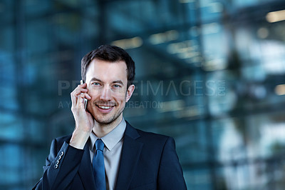 Buy stock photo Portrait of a confident young businessman talking on his mobile phone