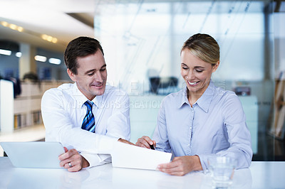 Buy stock photo Shot of a businessman and businesswoman working together in an office