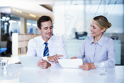Buy stock photo Shot of a businessman and businesswoman working together in an office