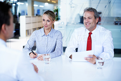 Buy stock photo Over the shoulder shot of a group of businesspeople talking while sitting in an office