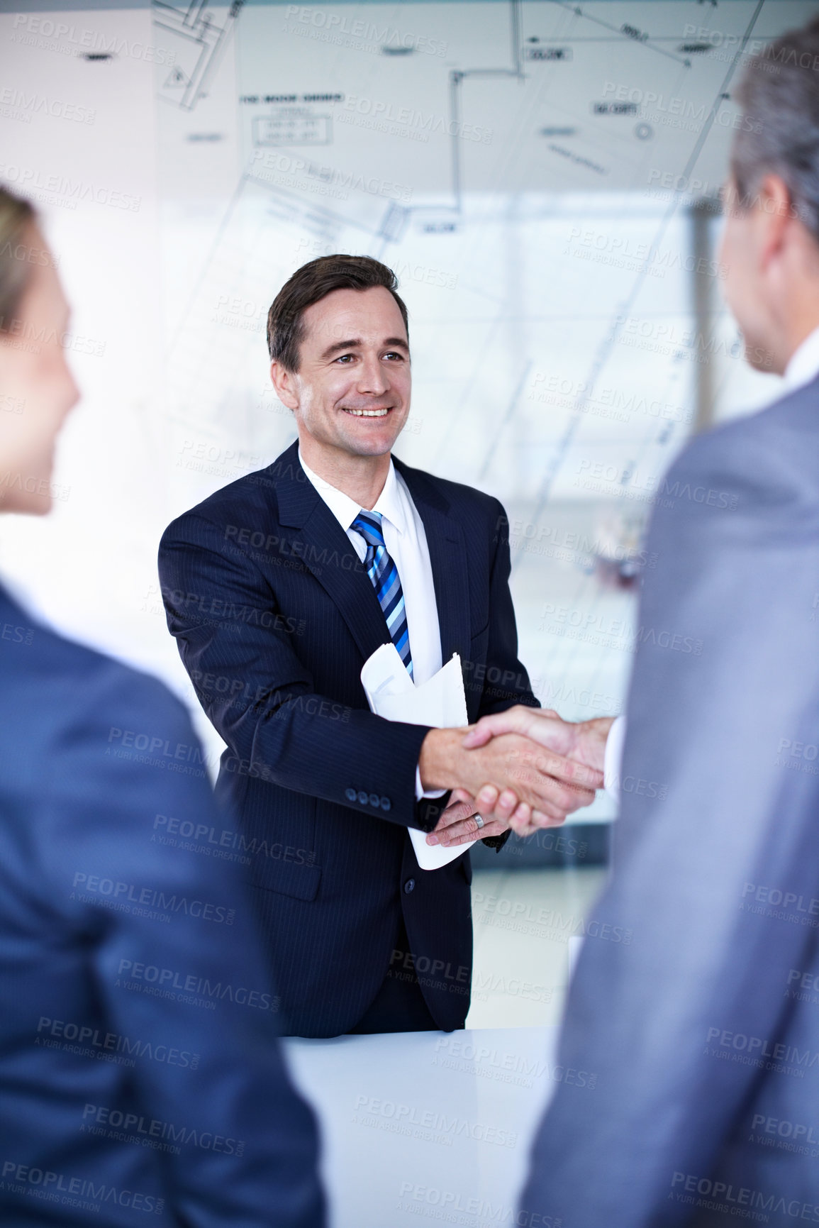 Buy stock photo Shaking hands, agreement and business people in office with deal, meeting and blueprint overlay. Welcome, discussion and architect firm with client for investment, contract or handshake for offer