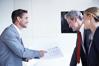 Buy stock photo Shot of a salesman talking to two businesspeople about computer accessories in an office