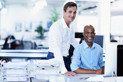 Buy stock photo Portrait of two coworkers at a workstation in an office