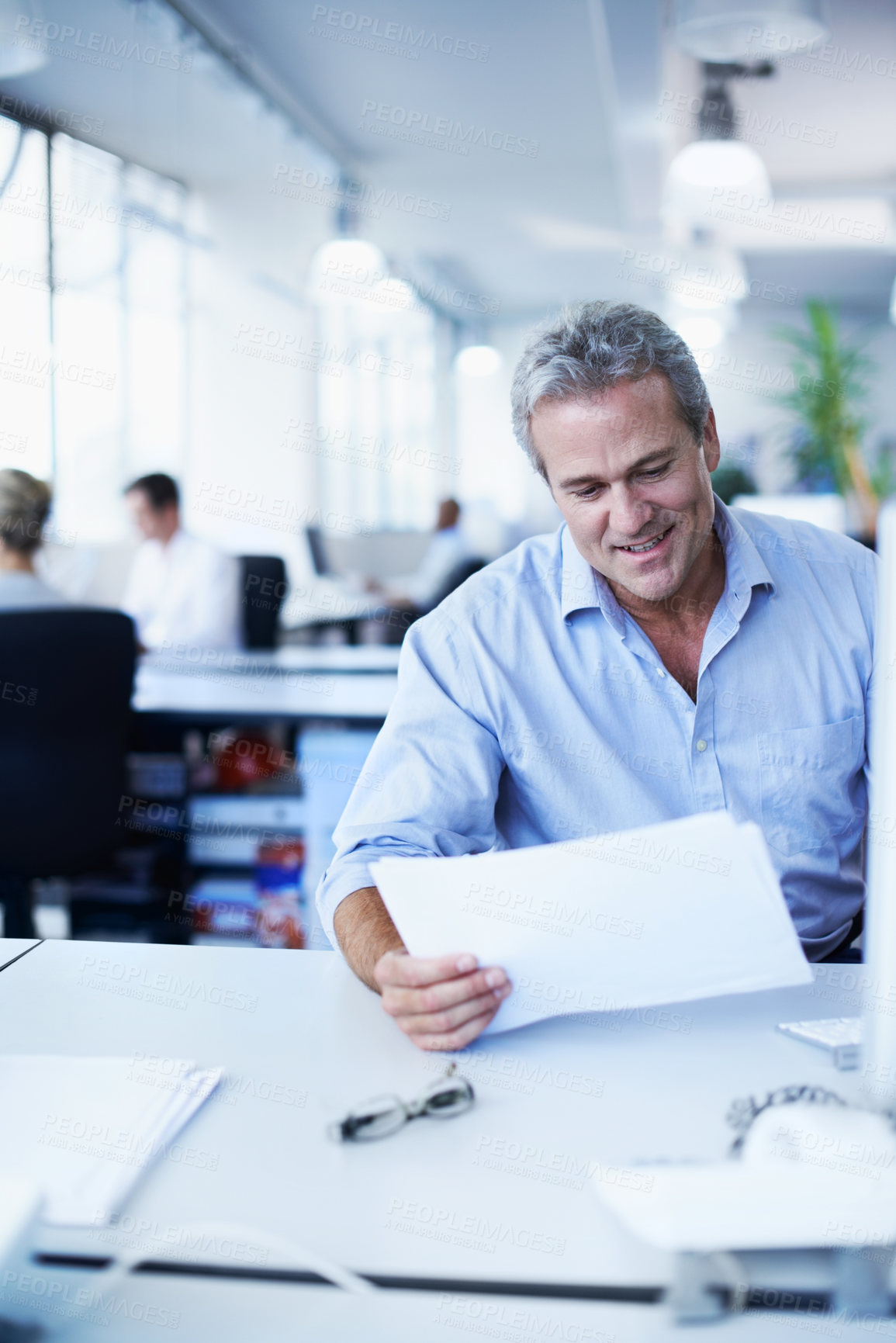 Buy stock photo Smile, documents and planning with business man in office for account review, administration and research. Bank records, deposit invoice and revenue paperwork with mature employee for budget