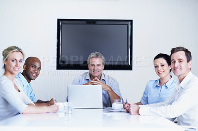 Buy stock photo Portait of a group of colleagues meeting around a boardroom table