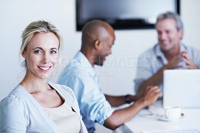 Buy stock photo Portrait of an attractive businesswoman sitting in a meeting with colleagues