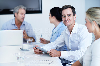 Buy stock photo Portrait of a handsome office worker during a meeting with colleagues