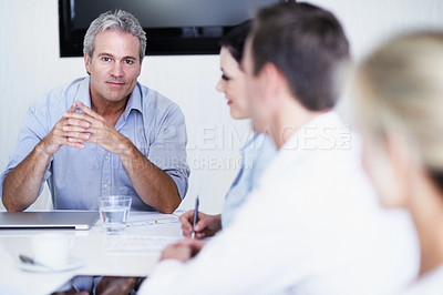 Buy stock photo Portrait of a manager and colleagues having a meeting around a boardroom table