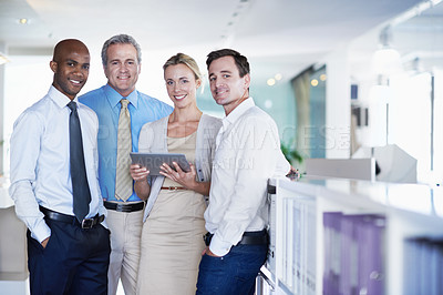Buy stock photo Portrait of a group of coworkers with a digital tablet standing in an office