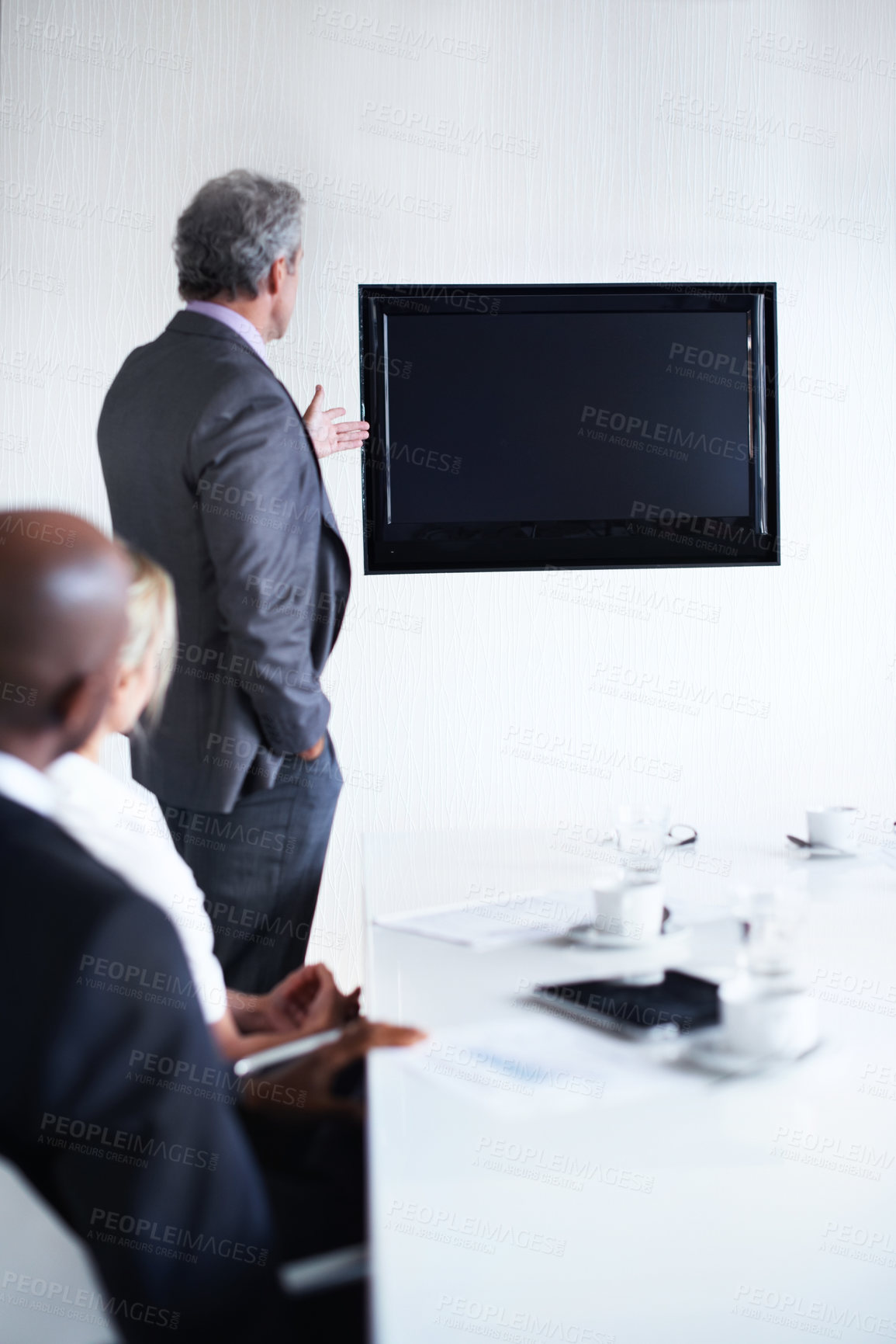 Buy stock photo CEO, screen or mockup in presentation with team, information or corporate pitch in office. Man, pointing and monitor with space for announcement, business proposal or discussion for collaboration