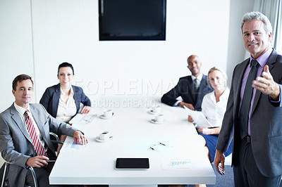 Buy stock photo Portrait of a diverse group of businesspeople sitting around a boardroom table