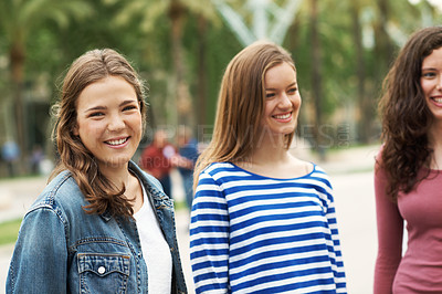 Buy stock photo Group of teen friends standing together and smiling while outdoors